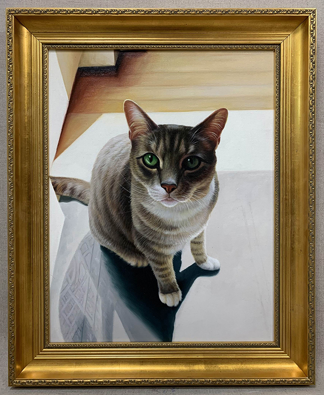 gold framed painting of sitting cat