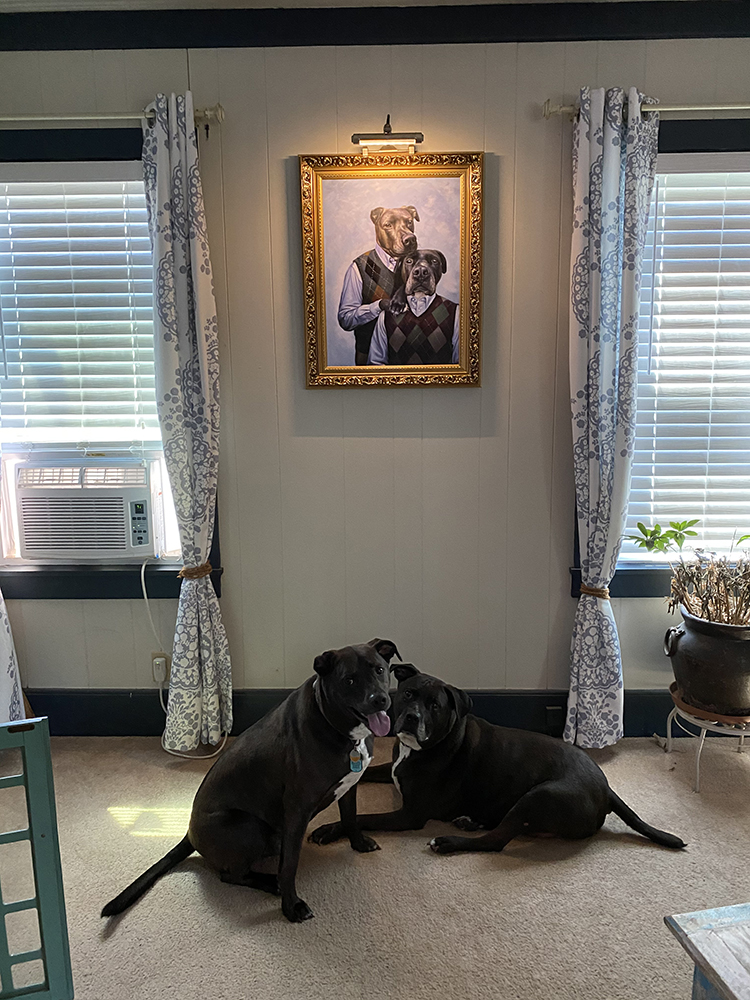 golden framed portrait with dogs